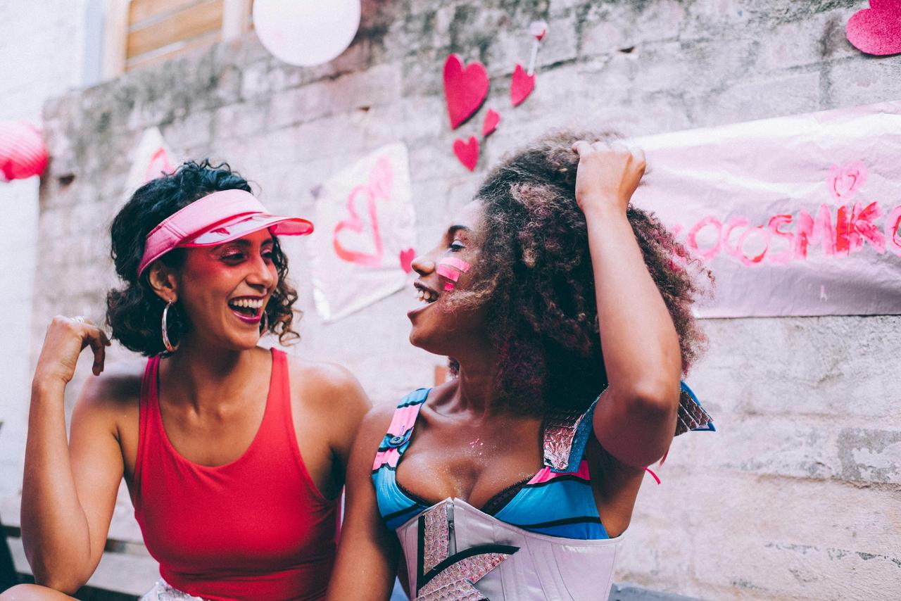 Two women smiling and laughing together on a valentine's day date