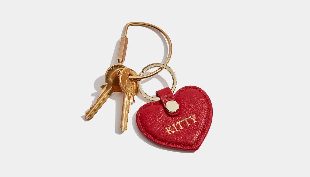 A red heart-shaped leather keyring that reads 