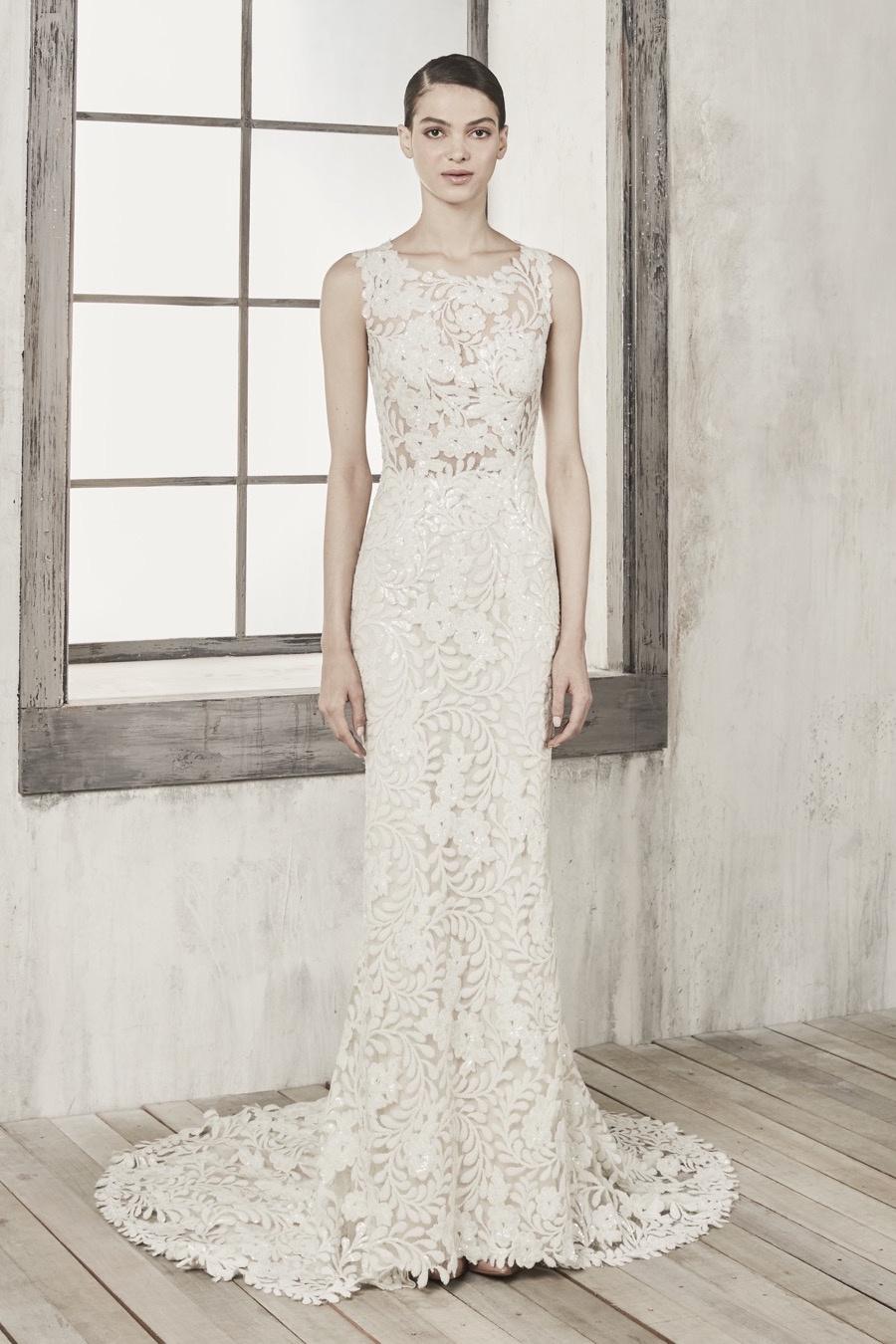 Image of a model wearing a lace dress with a neckline that stops at the collarbones