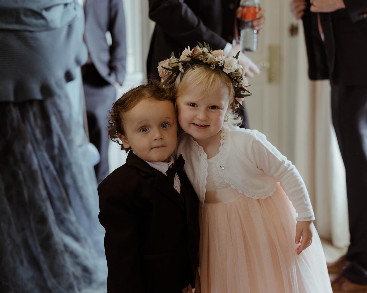 A page boy and flower girl pose for the camera