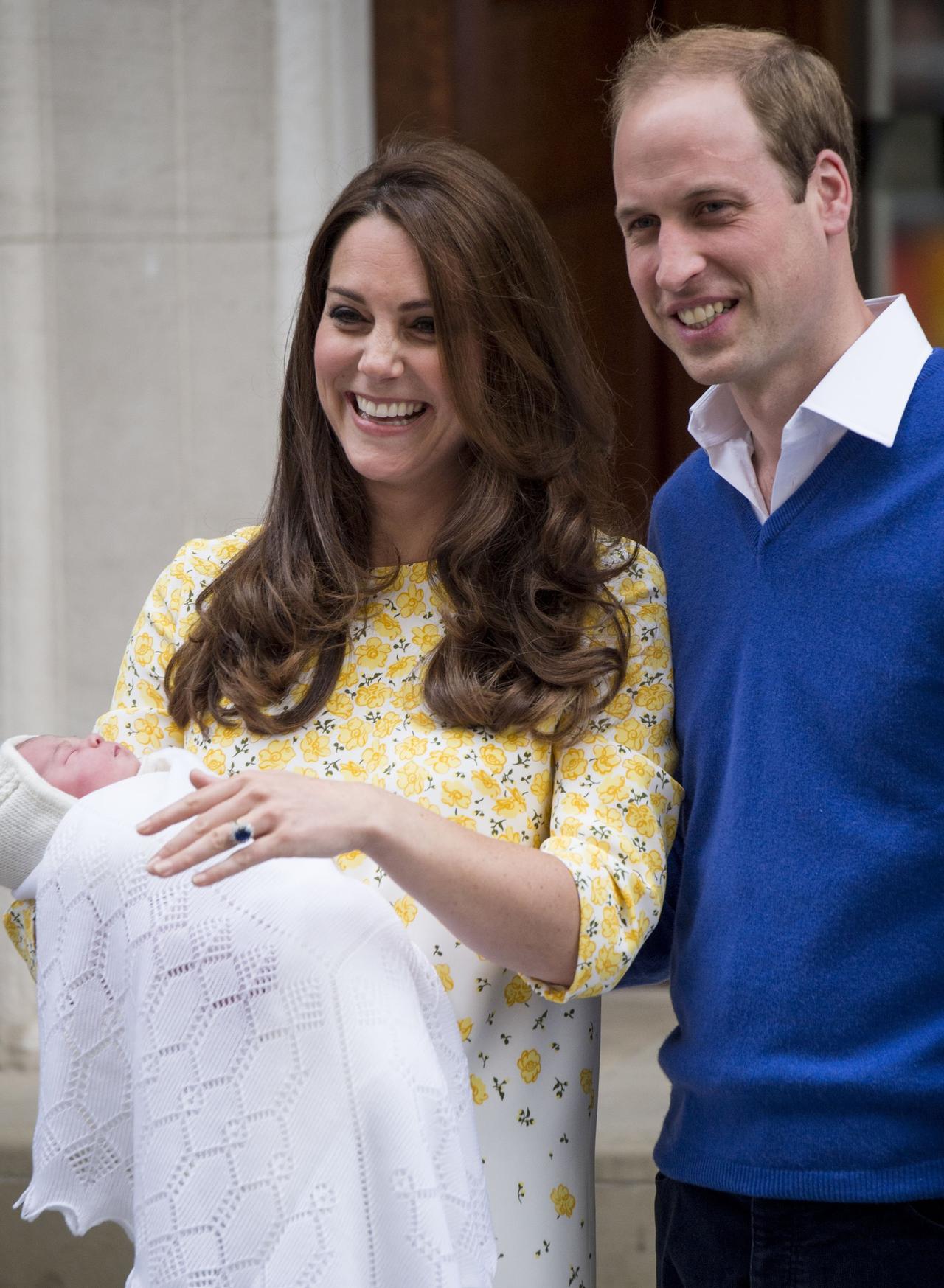 Kate Middleton and Prince William hold baby Charlotte in their arms