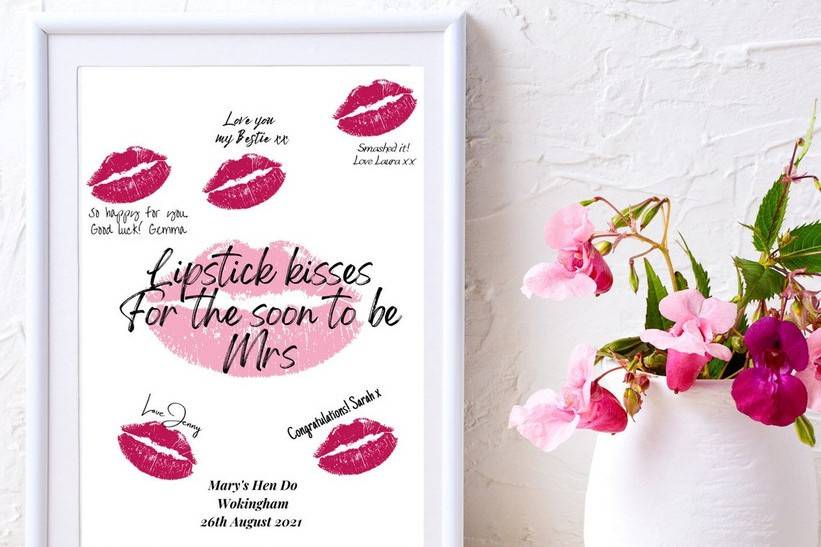 Lipstick kisses for the soon to be Mrs print next to a vase of flowers