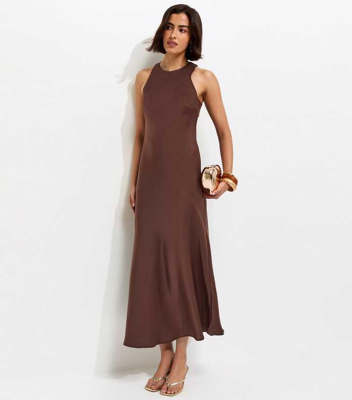 brunette model wearing a brown silky midi dress