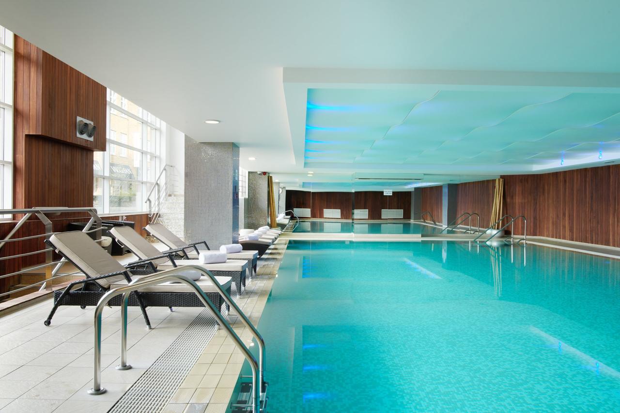 a blue swimming pool at the chelsea harbour hotel