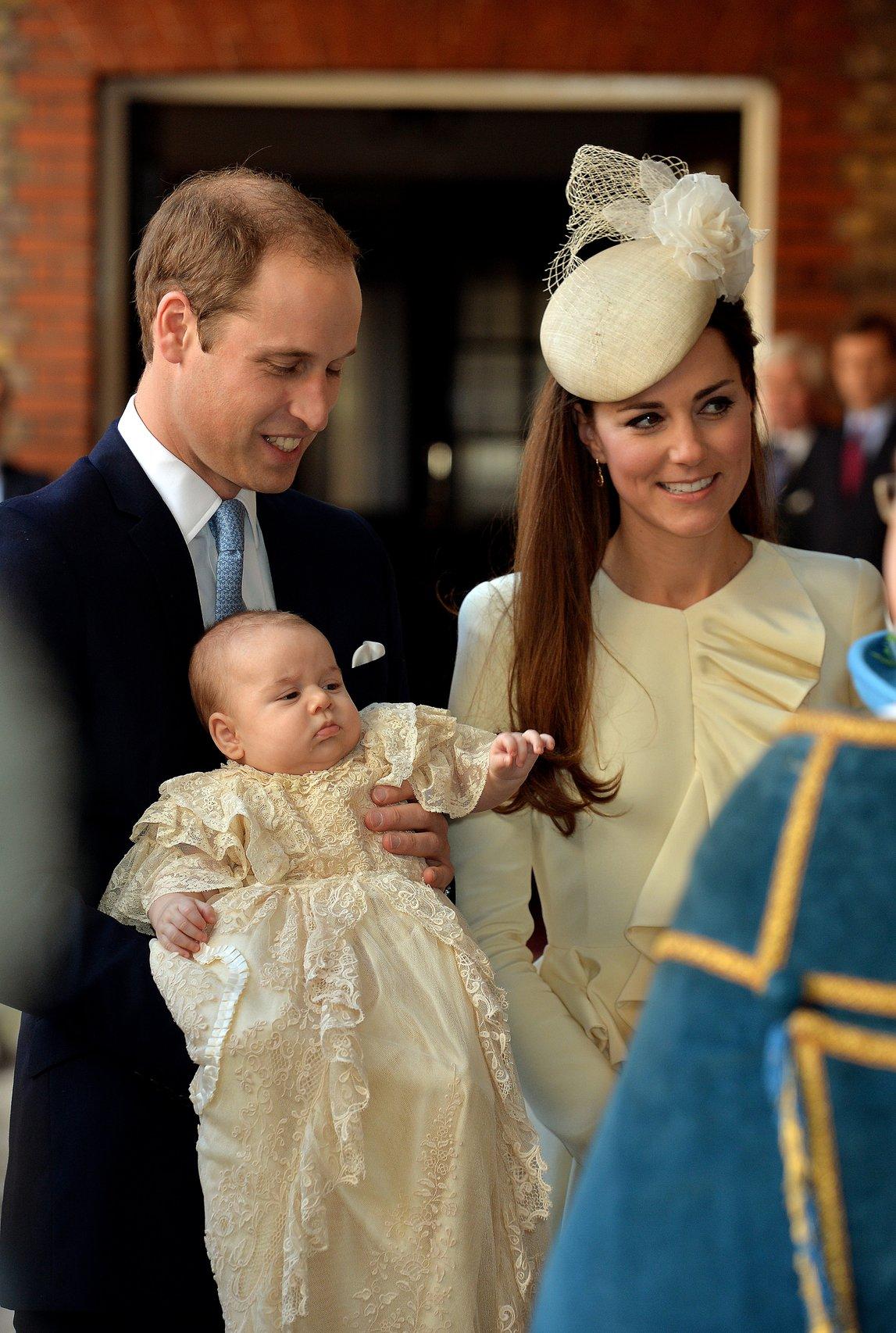 Kate Middleton and Prince William hold Prince George at his christening