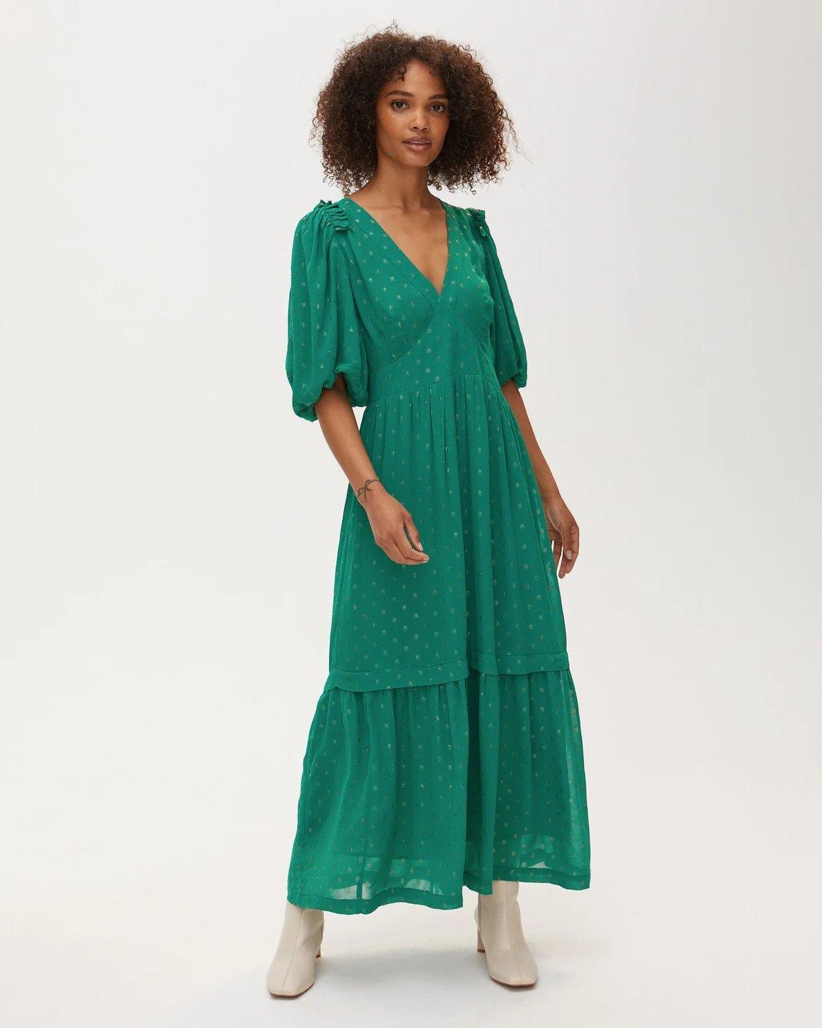 Green midi dress with ruffle shoulder detail and a subtle gold polka dot pattern