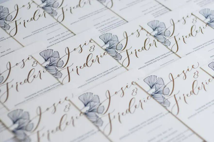 Gold and white wedding stationery with blue floral