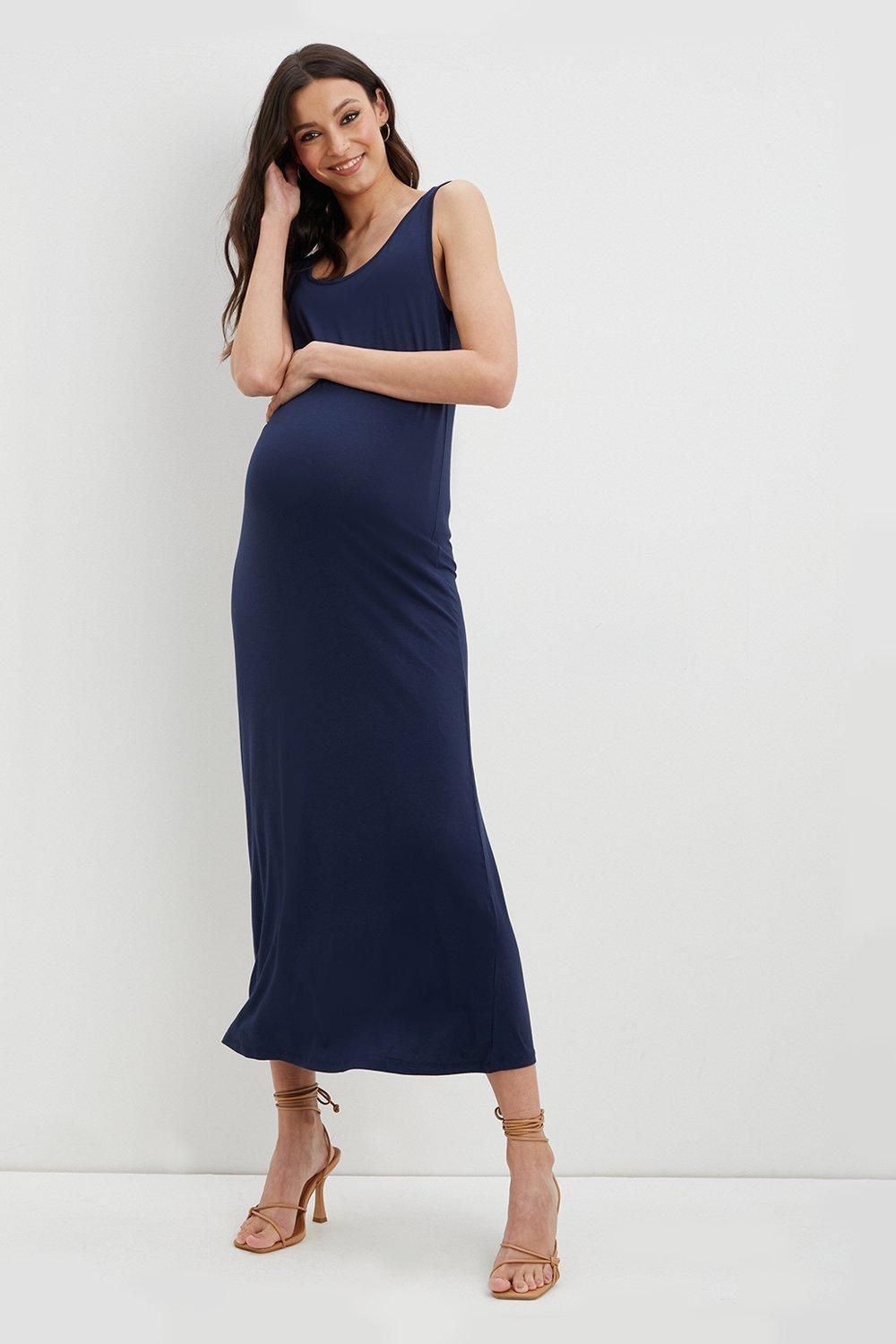 Model wearing a navy sleeveless maternity bridesmaid dress
