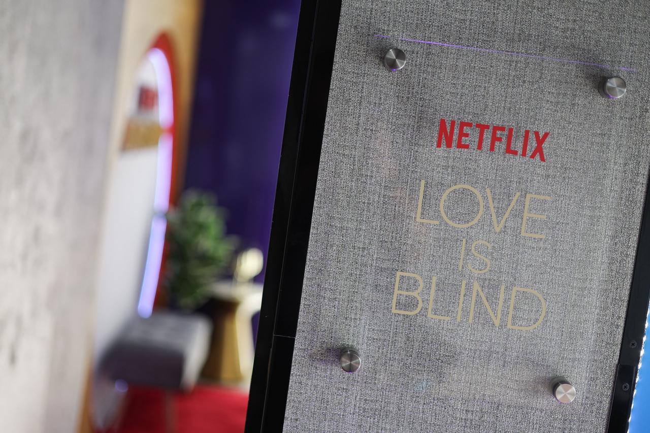 grey sign with love is blind and netflix logo on it 