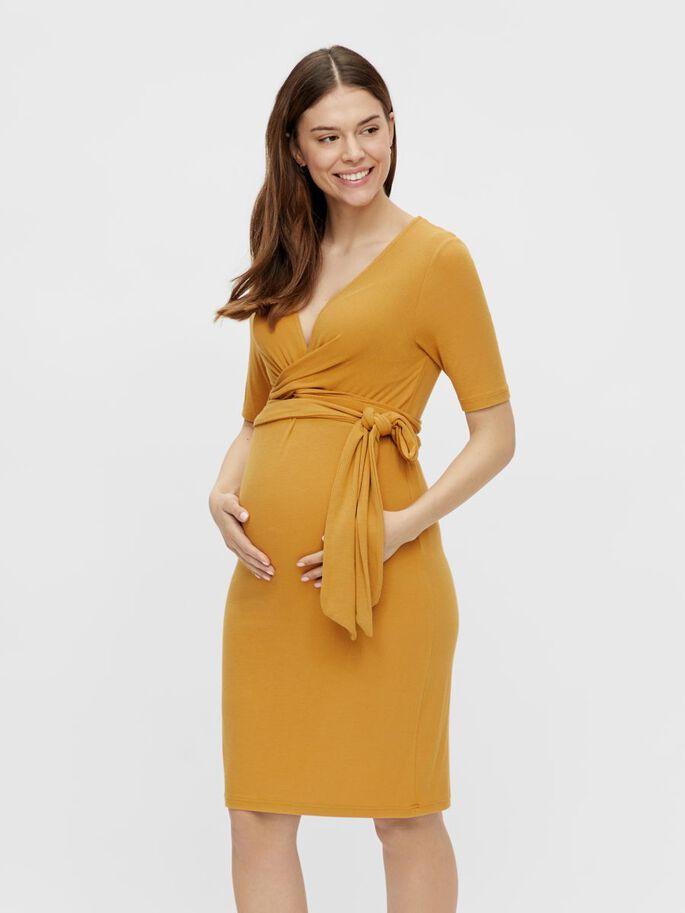 Pregnant model wearing a mustard wedding guest dress