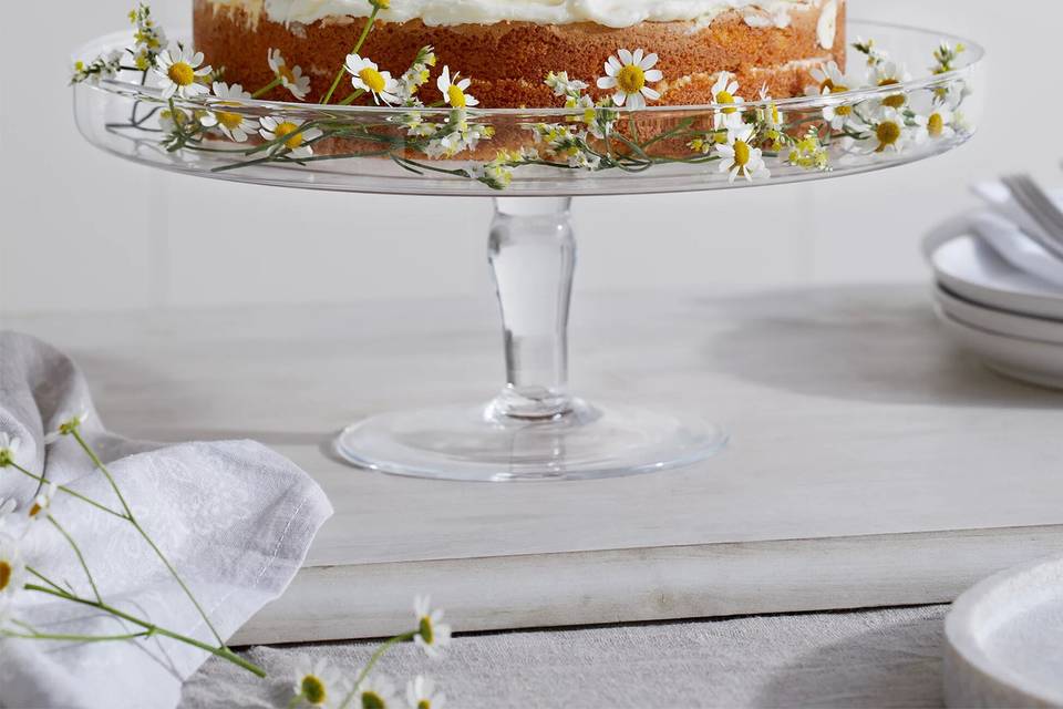 Glass wedding cake stand with daisies