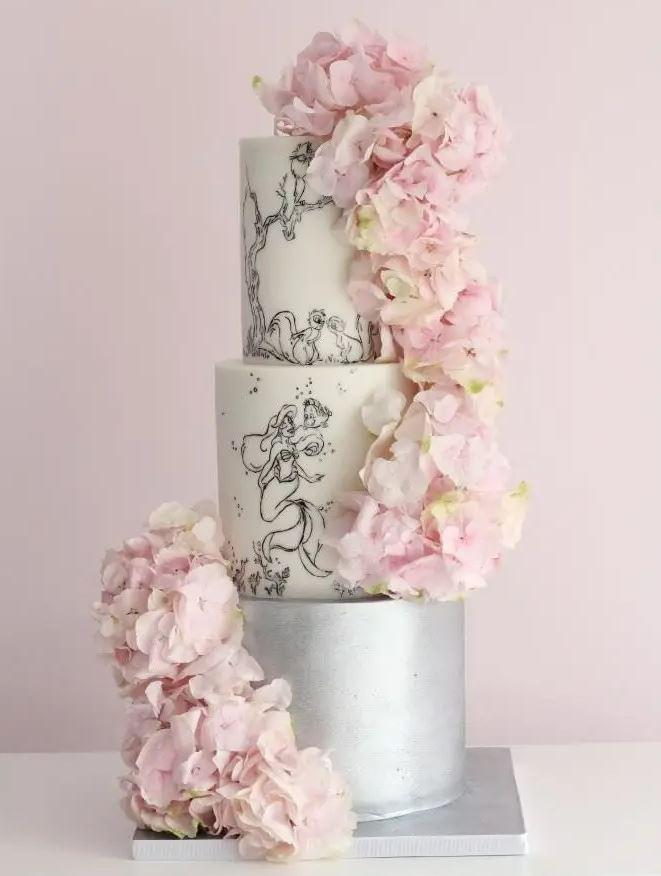 hand painted and illustrated Disney wedding cake with pink flowers
