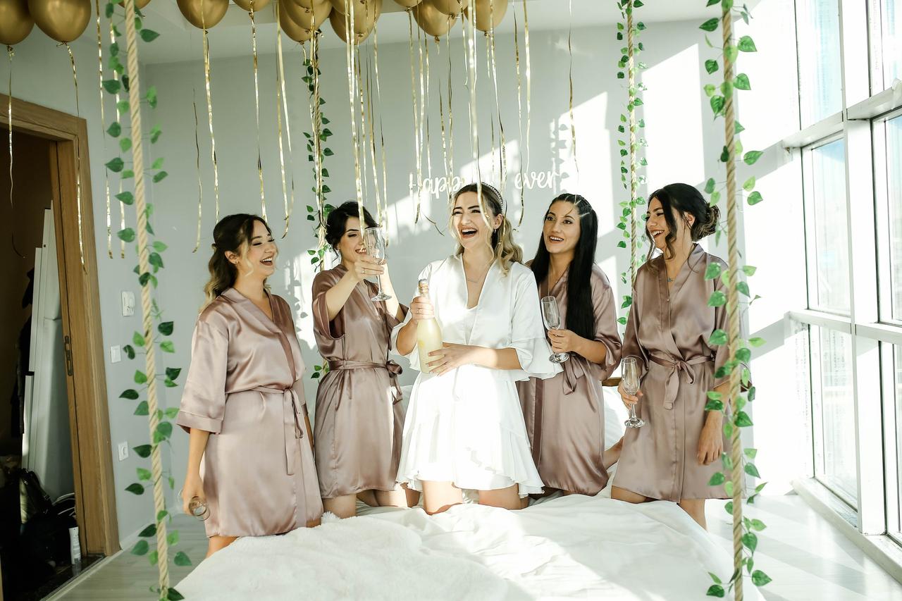 A bride and four bridesmaids in matching silk gowns