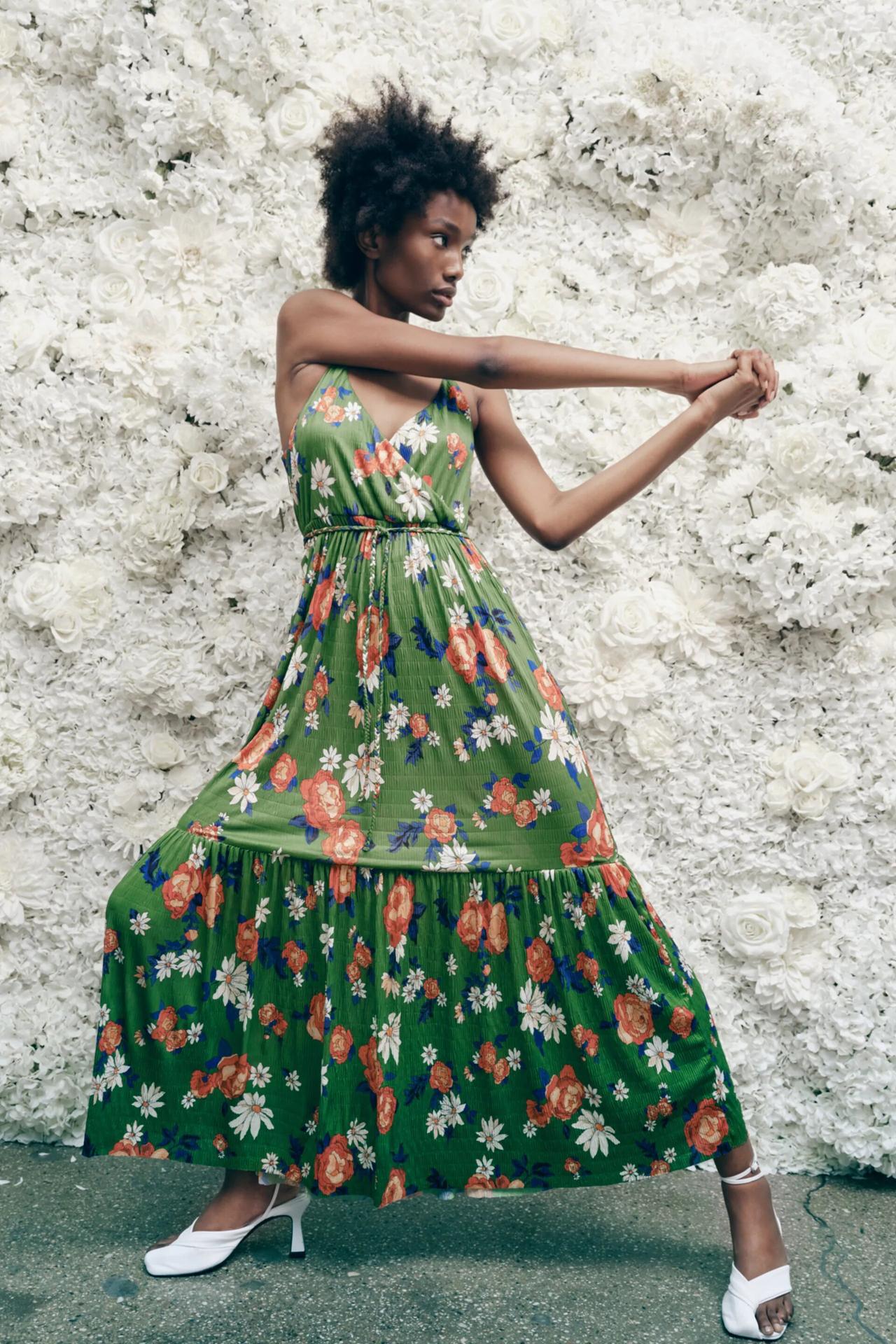 Model wearing a floral green wedding guest dress