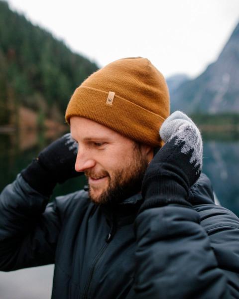 Model wearing a mustard beanie