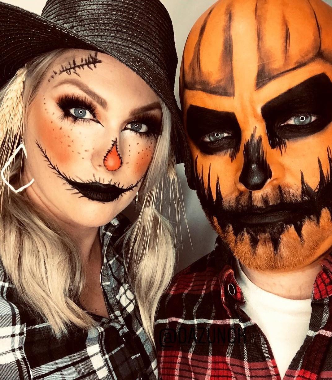 Young Creepy Woman With Halloween Makeup Mask In Scarecrow Costume