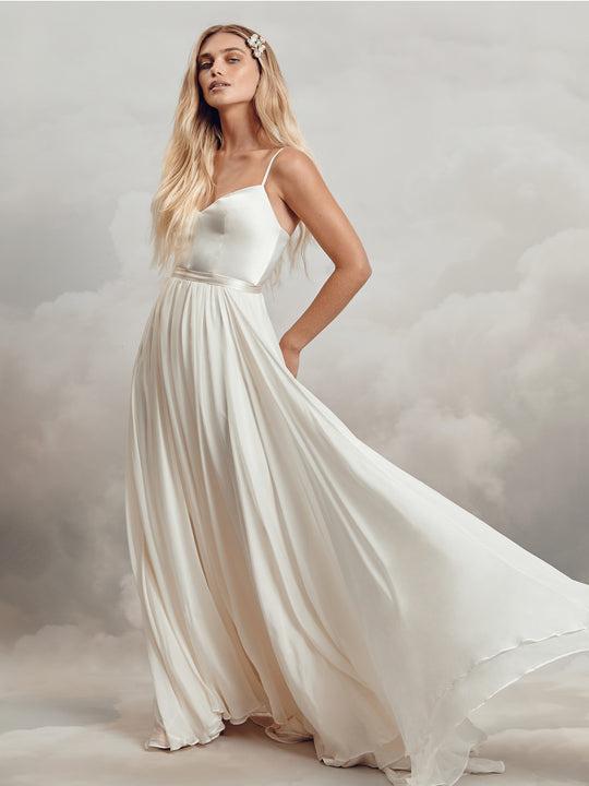 Model wearing a strappy satin wedding dress