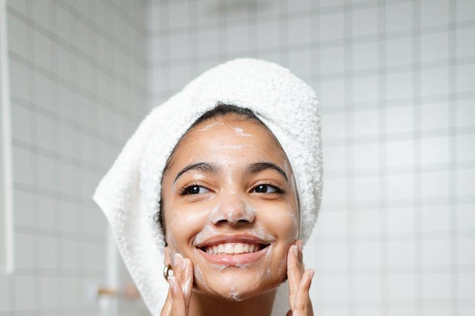 Woman applying facial treatment