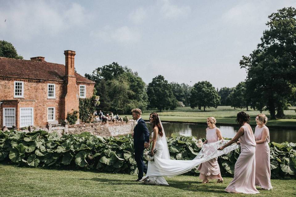 Bride, groom and bridesmaids outside a wedding venue