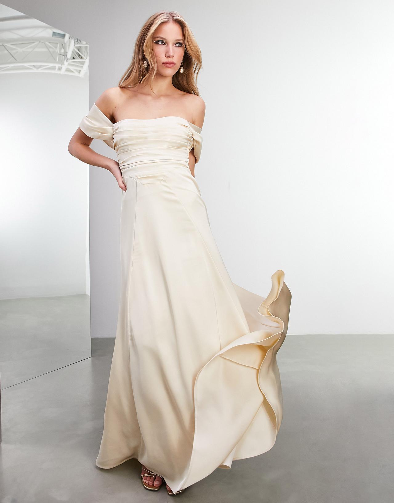 Model wearing an off the shoulder Champagne ombre wedding dress
