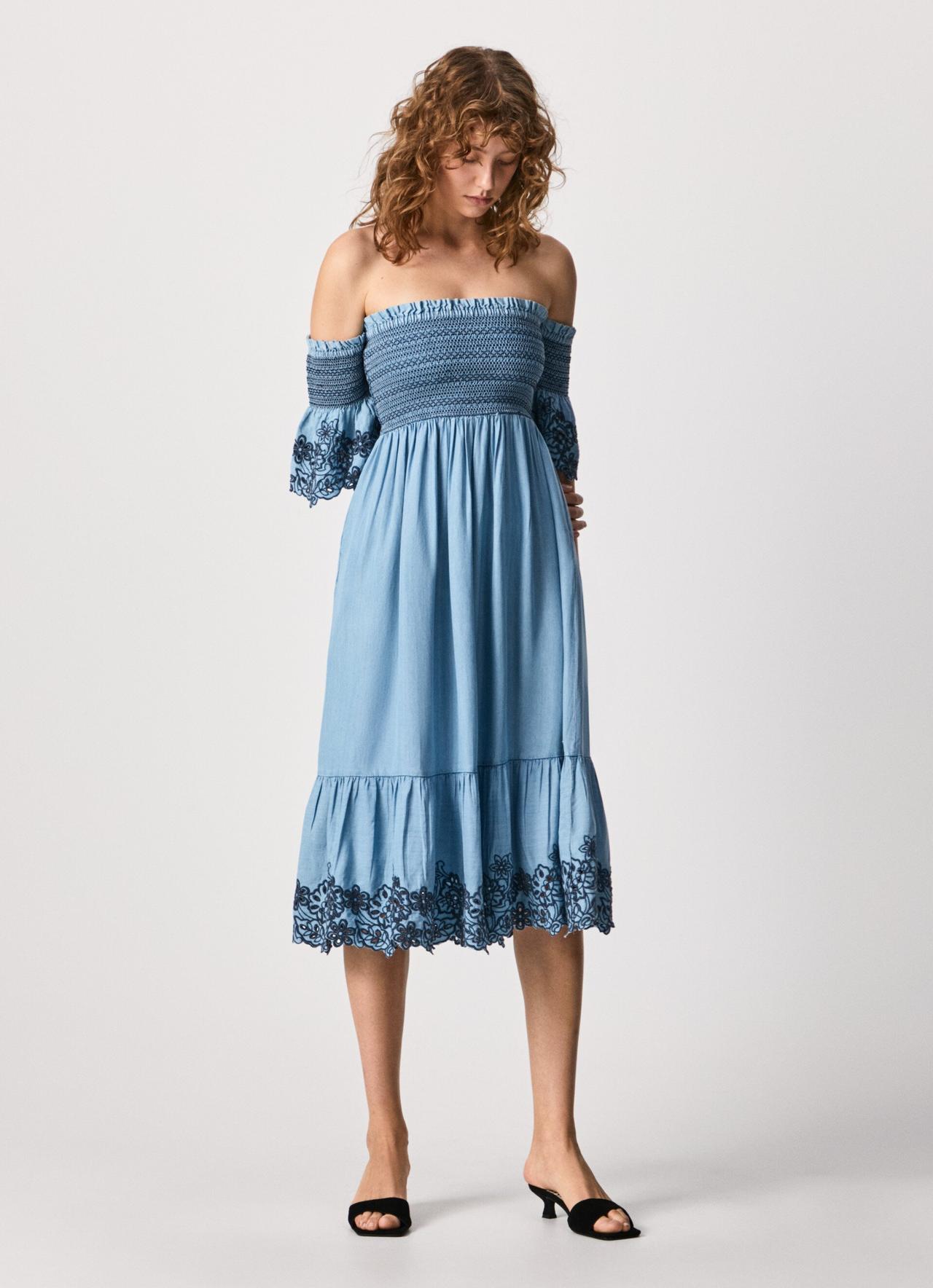 Image of a model wearing a blue off-the-shoulder midi dress with a smocked bodice and lace details 