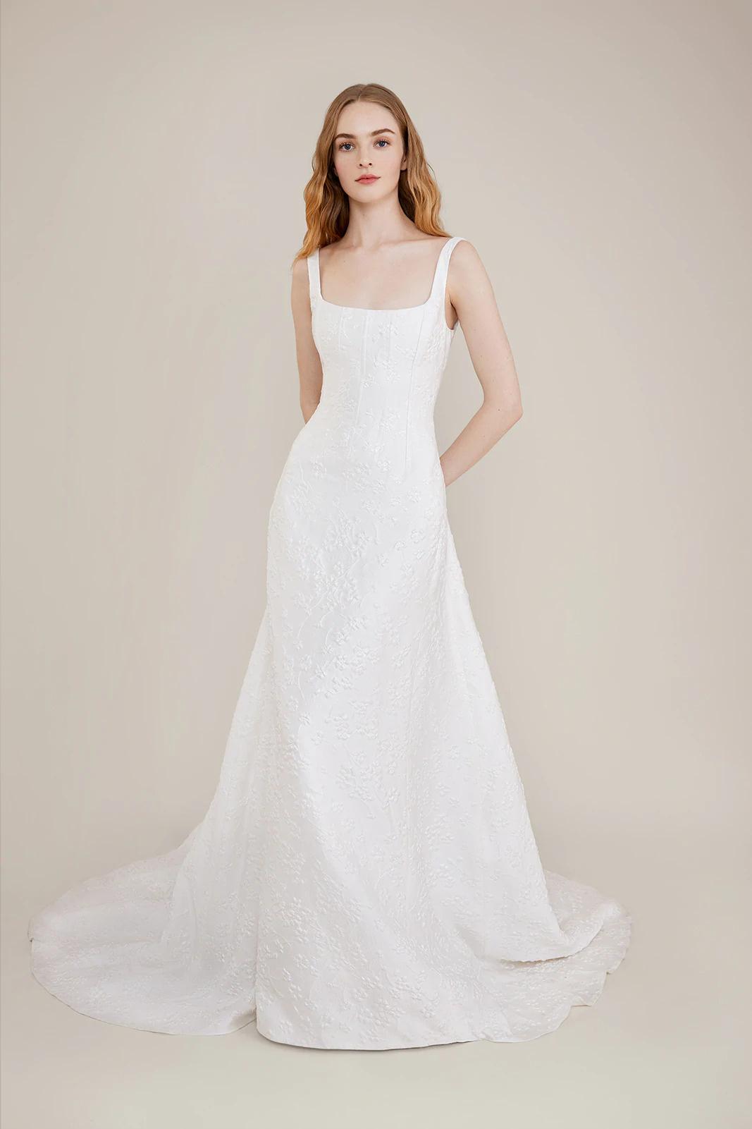 Model wearing an embroidered square neck wedding dress