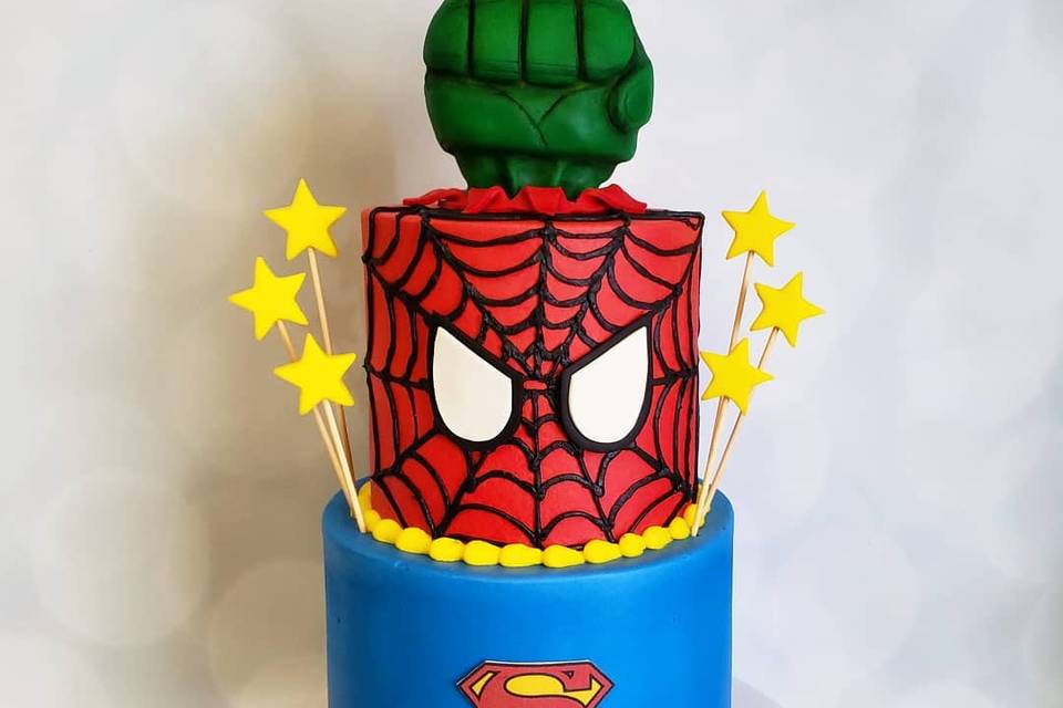 A three tier marvel wedding cake with Hulk fist at the top