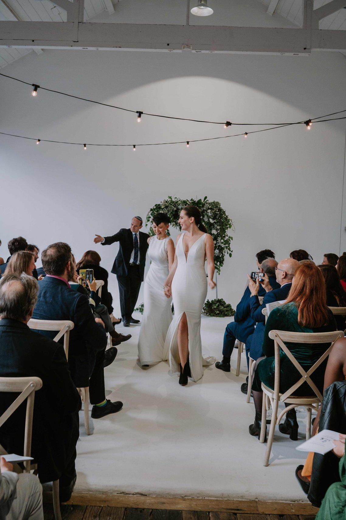 The brides walk back down the aisle
