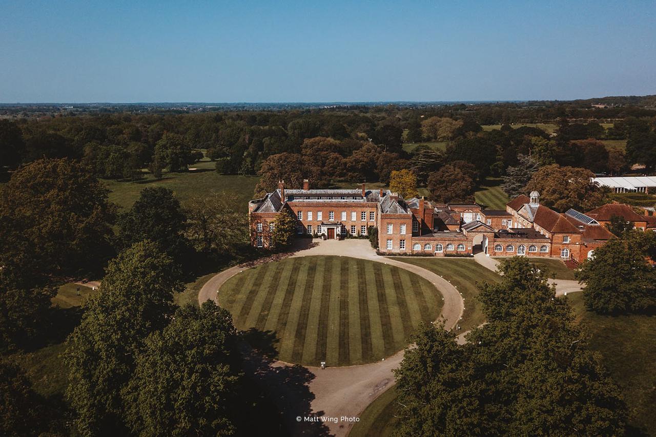 Aerial image of a stately home wedding venue with a circular lawn in the front