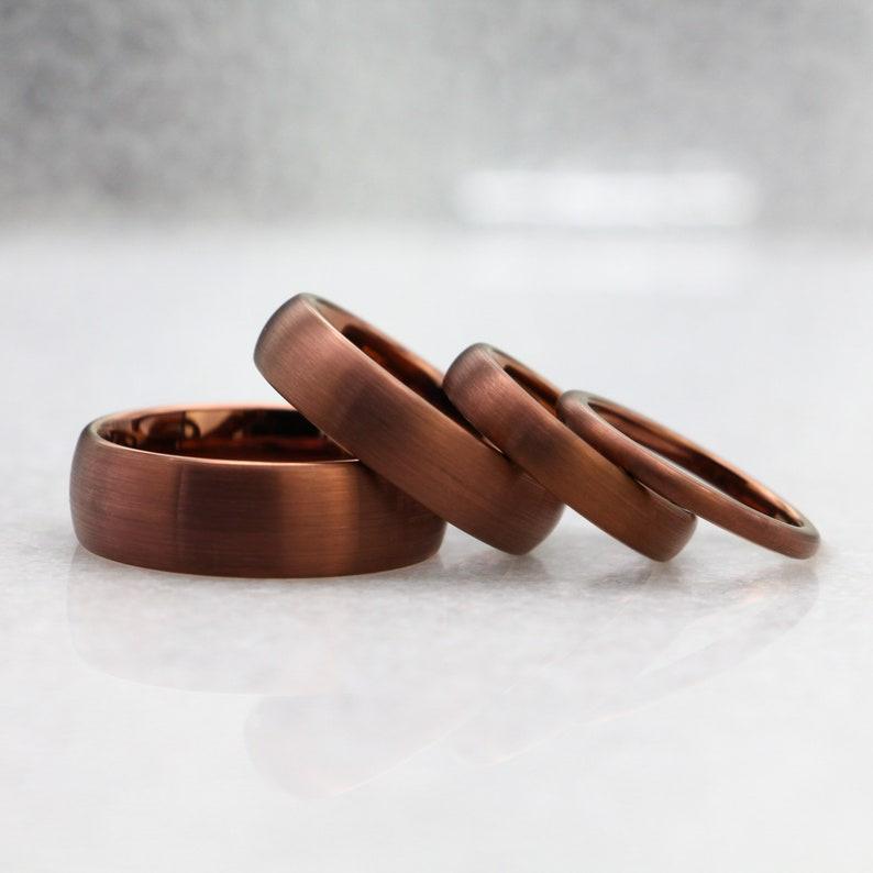 four brown tungsten wedding rings of different widths