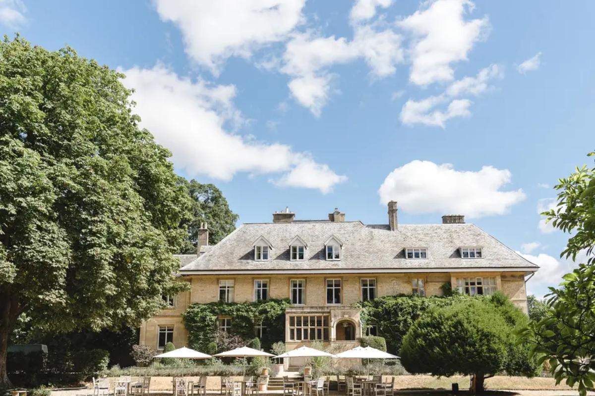 13 a garden view of the parasols and cream exterior at the slaughters manor house