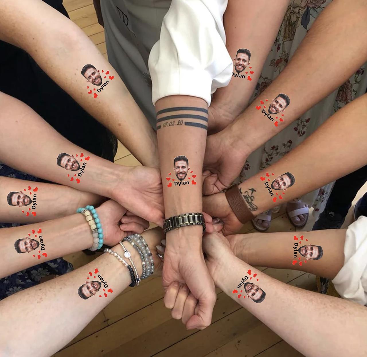 group of hens on a hen party holding out their arms showing personalised hen party tattoos