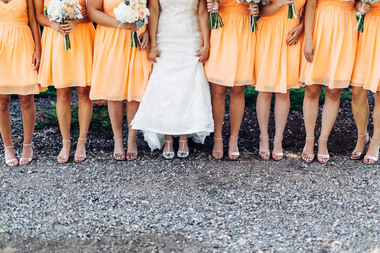 Low Section Of Bride With Bridesmaids Standing On Land