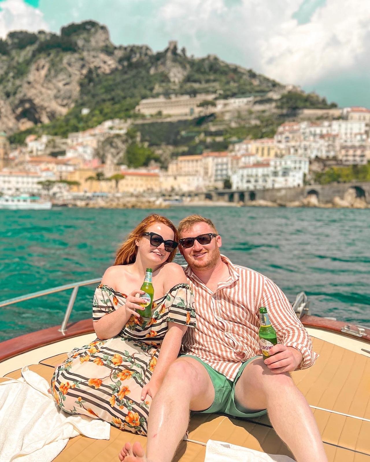 Person with ADHD and bride to be Lucinda, sitting on a boat with her fiance holding beers