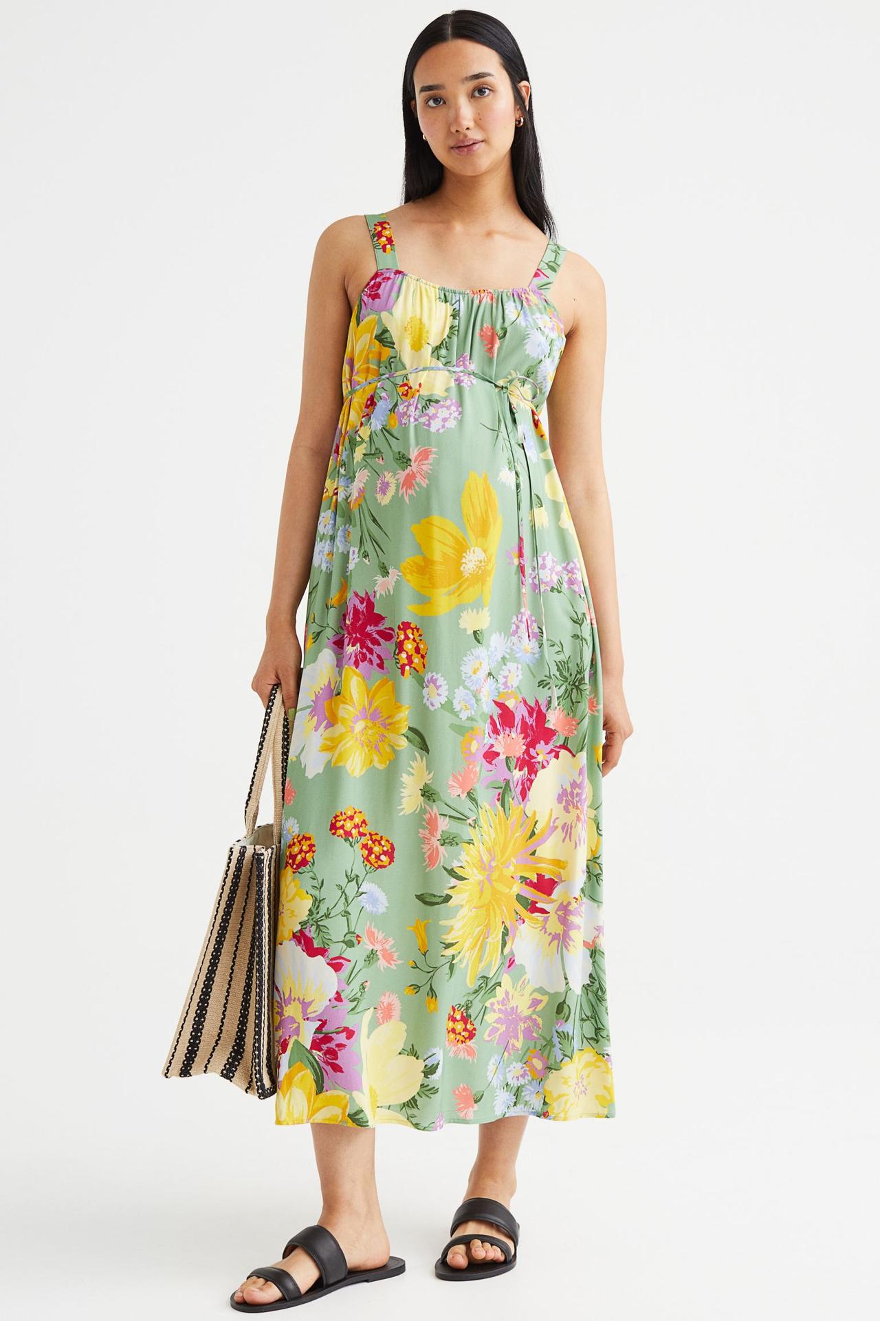 Model wearing a floral green maternity bridesmaid dress