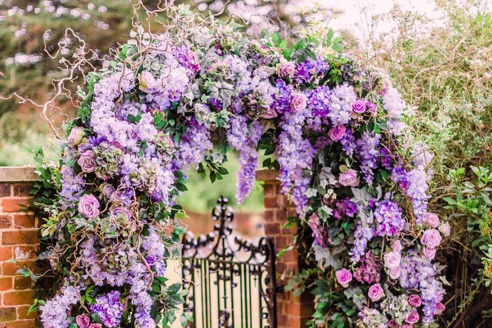 Lush floral arch idea for spring wedding