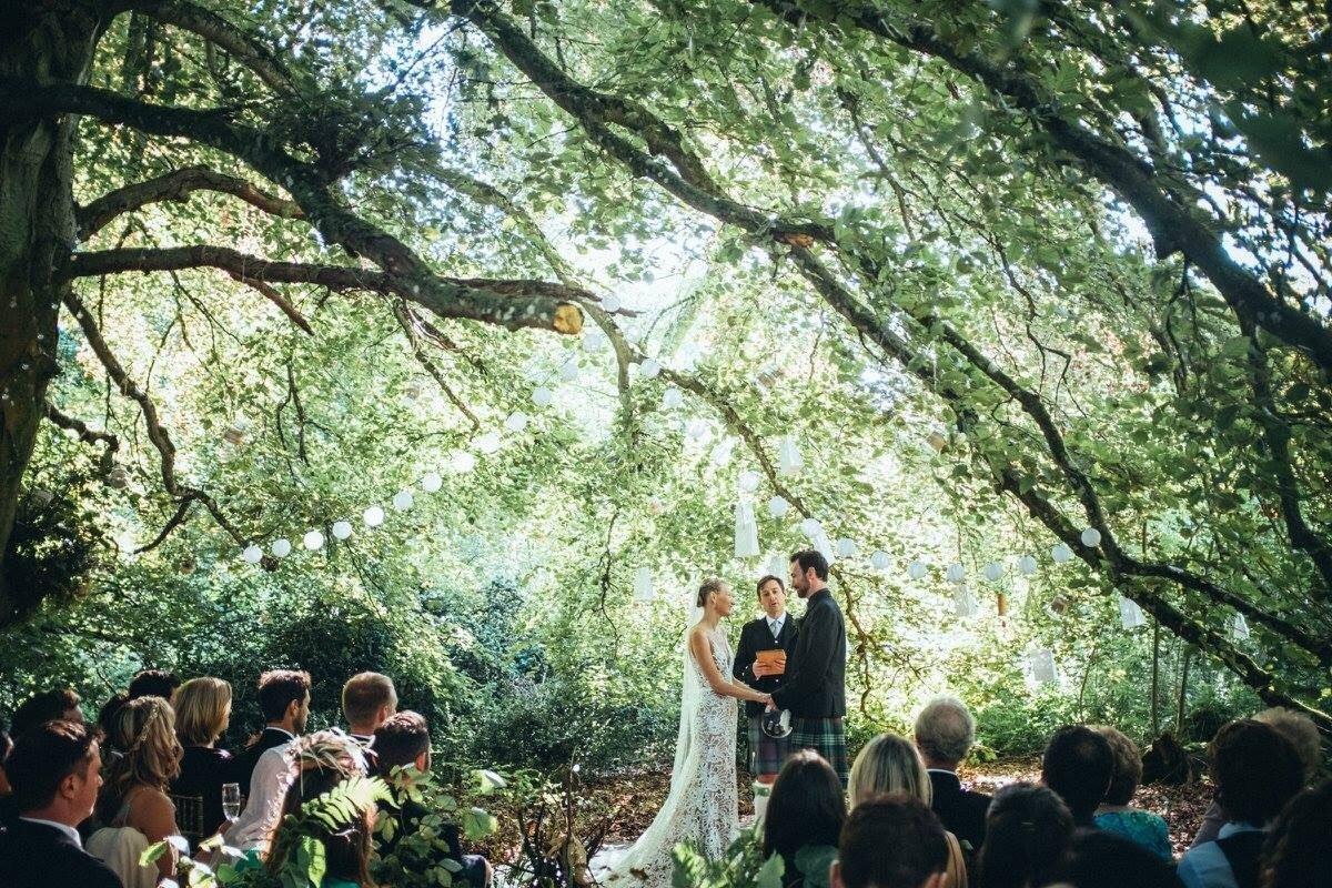 A couple get married outside in the forest at Kippilaw House