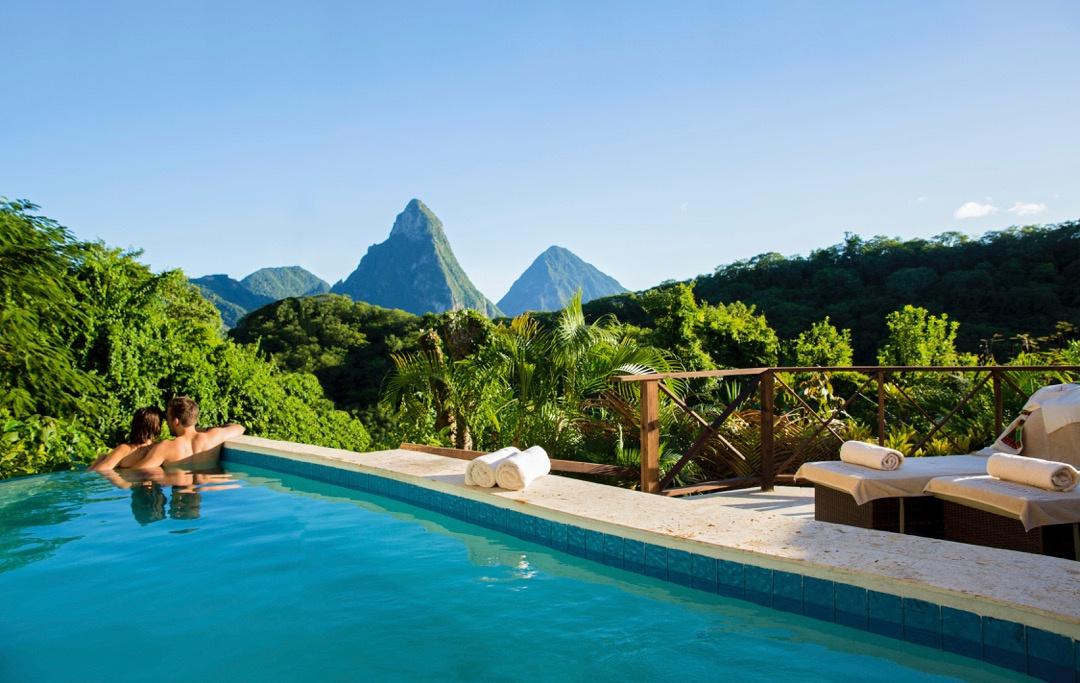 couple looking out from their private swimming pool across the island of St Lucia