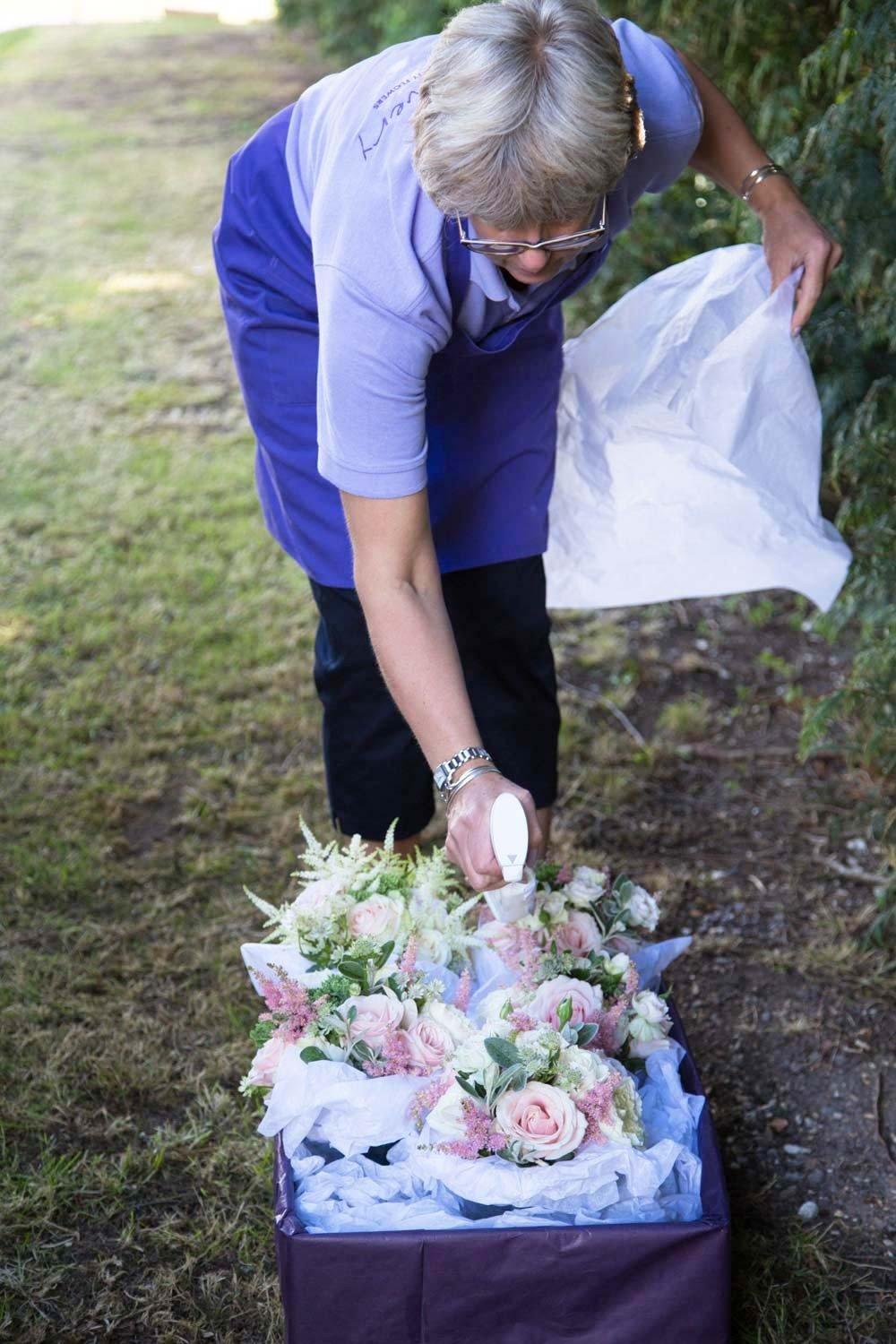 louise-from-louise-avery-flowers-spritzing-finished-bouquets-with-water