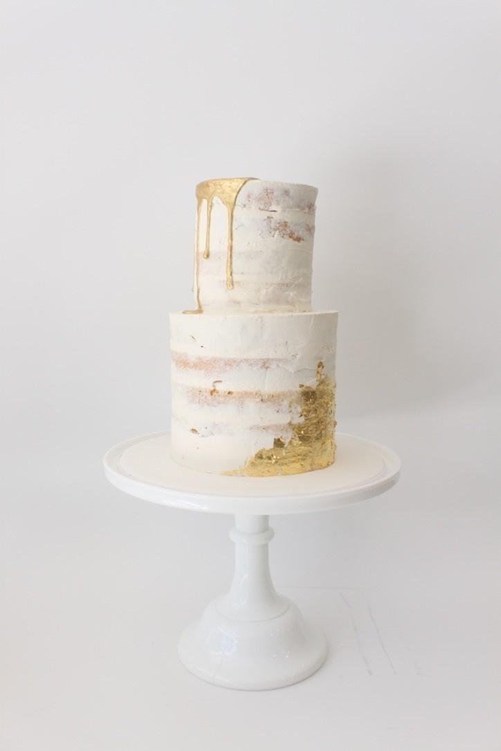 semi naked wedding cake with gold drip and gold leaf