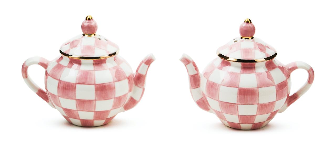 Two rose-coloured checkered salt and pepper shakers shaped like small teapots.
