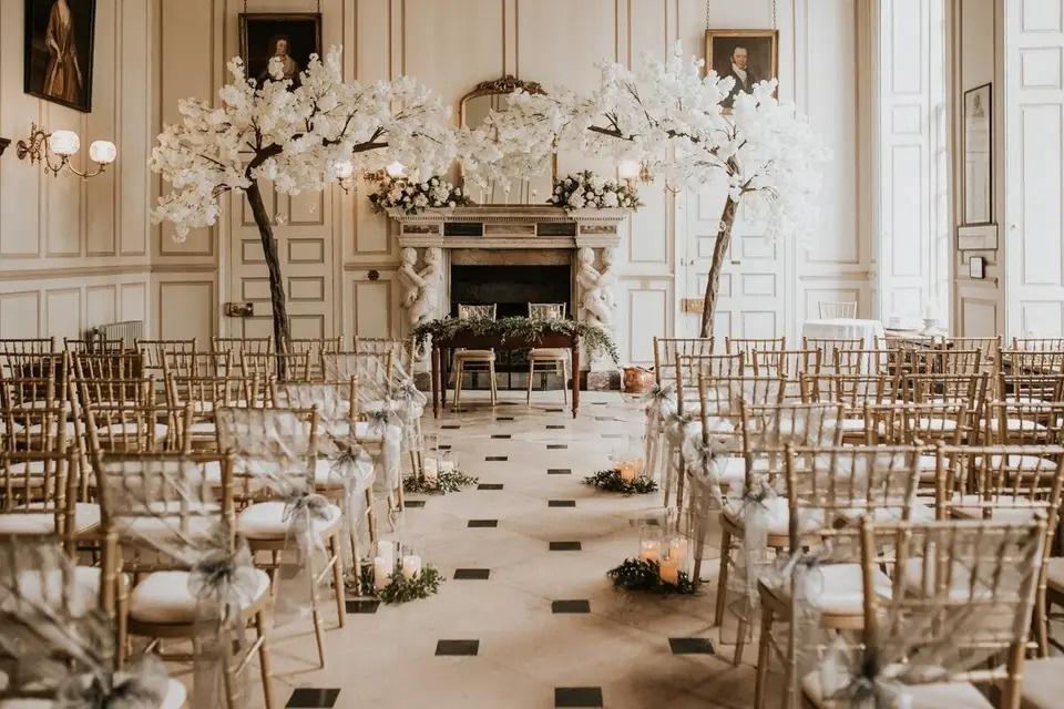 An elegant hall wedding with arch made from a white blossom tree 