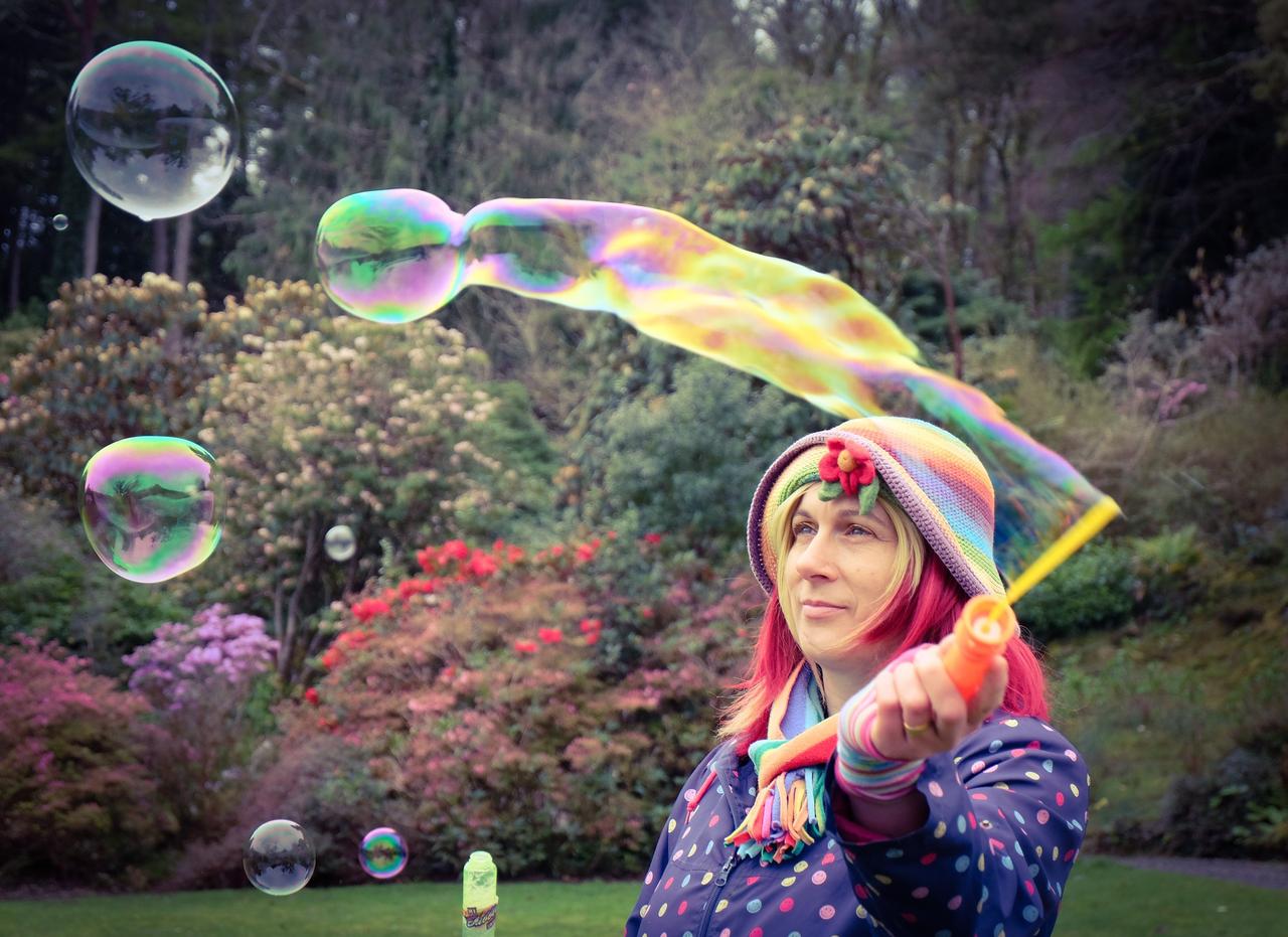 A children's wedding entertainer blowing giant bubbles