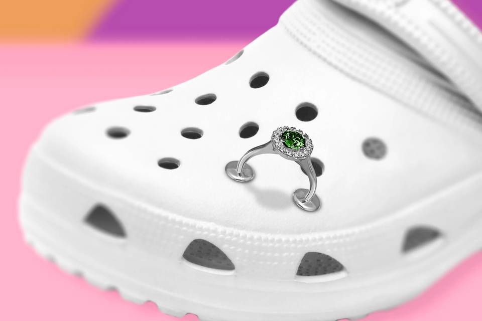 white wedding crocs against a colourful background with a diamond engagement ring croc charm