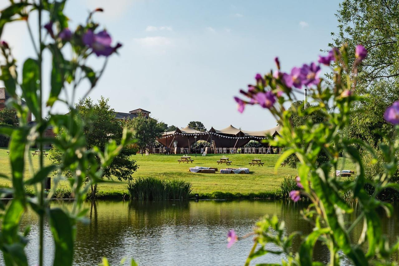 Stretch tent marquee wedding venue by the lake at Maisemore Court, Gloucestershire