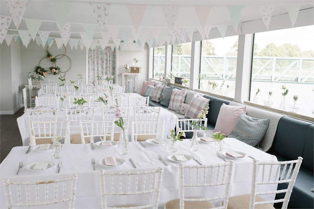 Interior of Northamptonshire wedding venue The Ark dressed for a wedding with pastel bunting
