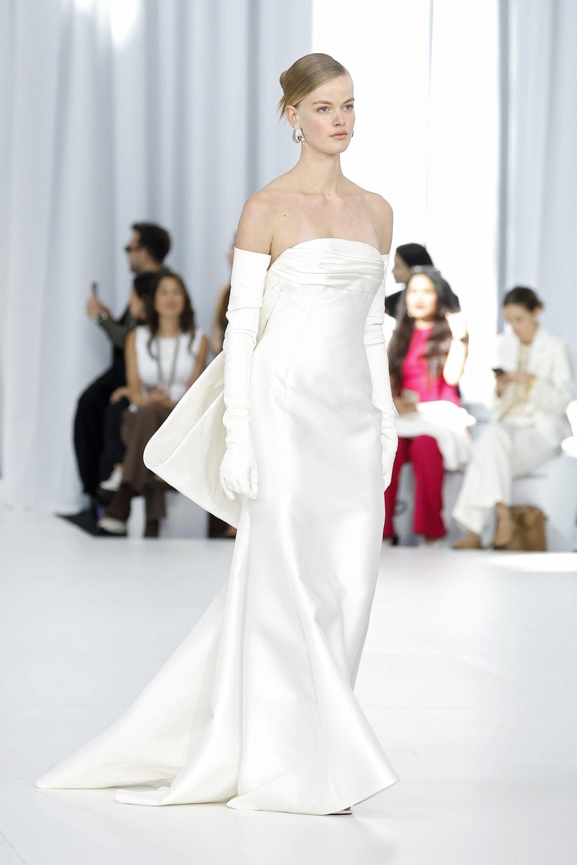 simple strapless wedding gown by Peter Langner with long white gloves worn by model at Barcelona bridal week 2026