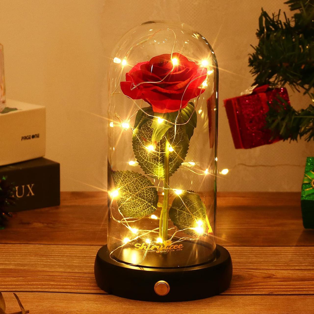 Eternal red rose in a glass dome with fairy lights