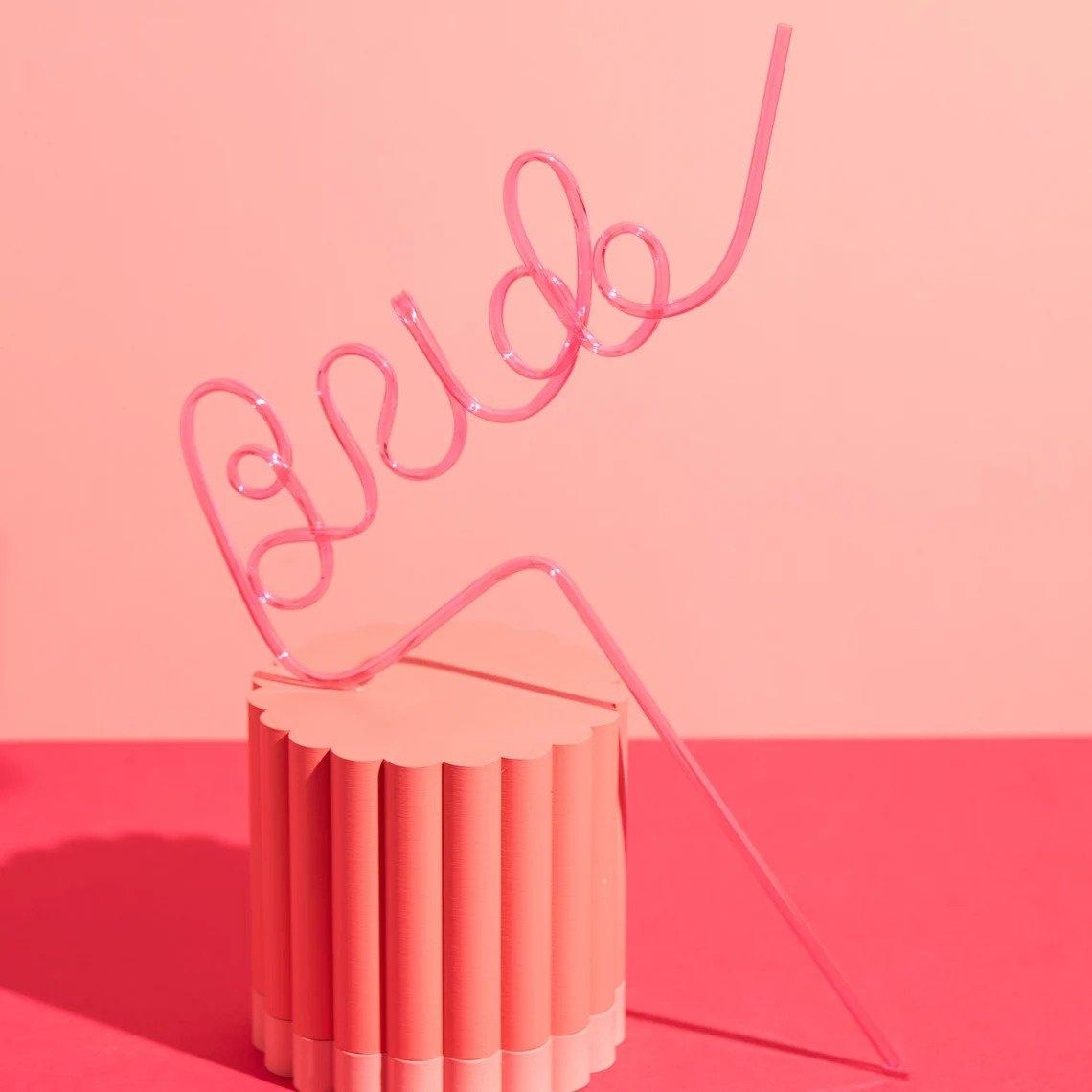A pink plastic bride straw