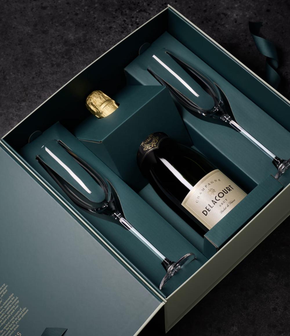 an elegant box from M&S holding two crystal champagne flutes and a bottle of champagne